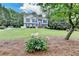 Beautiful home with a lush green lawn and garden with white flowers at 1818 Mcconnell Rd, Grayson, GA 30017