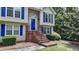 Inviting brick steps lead to a bright blue front door framed with brick detail at 1818 Mcconnell Rd, Grayson, GA 30017