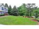 Landscaped front yard with trees and an expansive green lawn at 1818 Mcconnell Rd, Grayson, GA 30017