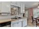 A well-maintained kitchen with white cabinets, laminate countertops, and a view into the dining area at 1818 Mcconnell Rd, Grayson, GA 30017