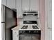 An efficient kitchen with white cabinets, stainless steel refrigerator, and a gas stove at 1818 Mcconnell Rd, Grayson, GA 30017