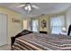 A cozy main bedroom with decorative ceiling fan and ample natural light at 1818 Mcconnell Rd, Grayson, GA 30017