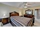 A main bedroom showcasing a decorative ceiling fan, a large bed, and a view of the ensuite bath at 1818 Mcconnell Rd, Grayson, GA 30017