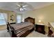 The main bedroom features a decorative ceiling fan, a large bed, and a mirror on the wall at 1818 Mcconnell Rd, Grayson, GA 30017