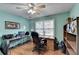 Bright office space with hardwood floors, desk, and shelving, creating an ideal work environment at 1818 Mcconnell Rd, Grayson, GA 30017