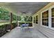 Covered outdoor patio, ideal for dining or relaxing, features a ceiling fan and view of the landscaped yard at 1818 Mcconnell Rd, Grayson, GA 30017