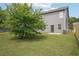 Spacious backyard featuring large mature tree, lush green grass, and patio at 2493 Oakleaf Rdg, Lithonia, GA 30058