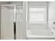 Bathroom showcasing a white bathtub with tile surround next to glass enclosed shower at 2493 Oakleaf Rdg, Lithonia, GA 30058