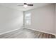 Bedroom featuring wood-look floors, a ceiling fan, and a window with blinds at 2493 Oakleaf Rdg, Lithonia, GA 30058