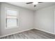 Bedroom featuring wood-look floors, a ceiling fan, and a window with blinds at 2493 Oakleaf Rdg, Lithonia, GA 30058