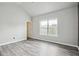 Bedroom with a window, light colored walls and hard wood floors, leading to a closet and bathroom at 2493 Oakleaf Rdg, Lithonia, GA 30058