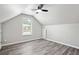 Bright bedroom features vaulted ceilings, modern fan, gray plank flooring, and natural light at 2493 Oakleaf Rdg, Lithonia, GA 30058