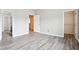 Bedroom with light colored walls and hard wood floors, leading to a closet and staircase at 2493 Oakleaf Rdg, Lithonia, GA 30058