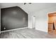 Spacious bedroom with a window, vaulted ceilings, gray accent wall and light-colored hard wood flooring at 2493 Oakleaf Rdg, Lithonia, GA 30058