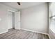 Bright bedroom features wood-look floors, a window with blinds and walk in closet at 2493 Oakleaf Rdg, Lithonia, GA 30058