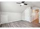 Bright bedroom features vaulted ceilings, modern fan, gray plank flooring, and closet at 2493 Oakleaf Rdg, Lithonia, GA 30058