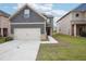 Charming two-story home with a two car garage, landscaped front yard and craftsman style accents at 2493 Oakleaf Rdg, Lithonia, GA 30058