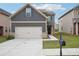 Charming two-story home with a two car garage, landscaped front yard and craftsman style accents at 2493 Oakleaf Rdg, Lithonia, GA 30058