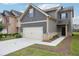 Charming two-story home with a two car garage, landscaped front yard and craftsman style accents at 2493 Oakleaf Rdg, Lithonia, GA 30058
