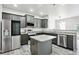 Modern kitchen featuring stainless steel appliances, gray cabinets, granite countertops, and an island at 2493 Oakleaf Rdg, Lithonia, GA 30058