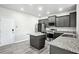 Modern kitchen featuring gray cabinets, granite counters, stainless steel appliances, and wood flooring at 2493 Oakleaf Rdg, Lithonia, GA 30058