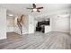 Open-concept living space with wood flooring, staircase, kitchen view, and bright lighting at 2493 Oakleaf Rdg, Lithonia, GA 30058
