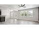 Spacious living room featuring wood flooring, natural light, and an elegant light fixture at 2493 Oakleaf Rdg, Lithonia, GA 30058