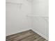 Walk-in closet featuring multiple shelves and light-colored hard wood floors at 2493 Oakleaf Rdg, Lithonia, GA 30058