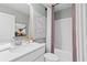 Bright bathroom featuring a modern vanity, artwork, and tiled shower with a decorative shower curtain at 336 Heavenly Hollow Pl, Mcdonough, GA 30253