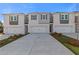 View of new townhomes with attached garages and modern exteriors under blue sky at 336 Heavenly Hollow Pl, Mcdonough, GA 30253