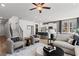 A comfortable living room with a ceiling fan and open access to the modern kitchen and dining area at 336 Heavenly Hollow Pl, Mcdonough, GA 30253