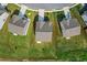 An aerial view showcases the rooftops and neatly manicured lawns of three adjacent properties at 49 Ryder Pass Way, Loganville, GA 30052