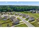 An expansive aerial view of a neighborhood featuring homes, streets, and green spaces at 49 Ryder Pass Way, Loganville, GA 30052