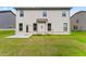 This home features a lush green backyard and a patio at 49 Ryder Pass Way, Loganville, GA 30052