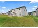 The backyard of the home includes a grassy lawn and many other houses nearby at 49 Ryder Pass Way, Loganville, GA 30052