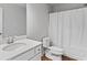 Clean bathroom featuring a sink with modern fixtures, toilet, and a shower with a white curtain at 49 Ryder Pass Way, Loganville, GA 30052