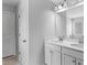 Well-lit bathroom featuring a double vanity with white cabinets and countertops, and modern fixtures at 49 Ryder Pass Way, Loganville, GA 30052