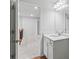 Bright bathroom vanity with a large mirror and modern fixtures at 49 Ryder Pass Way, Loganville, GA 30052