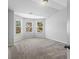 Bright bedroom featuring neutral carpet and several windows at 49 Ryder Pass Way, Loganville, GA 30052