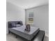 Cozy bedroom with a modern bed frame, soft gray tones, and plush carpeting at 49 Ryder Pass Way, Loganville, GA 30052