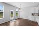 Cozy breakfast nook featuring hardwood floors, natural light, and a modern chandelier at 49 Ryder Pass Way, Loganville, GA 30052