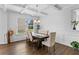 Elegant dining room featuring a modern chandelier, trim accents and a large window at 49 Ryder Pass Way, Loganville, GA 30052