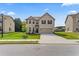 Charming two-story brick home featuring a manicured lawn and a two-car attached garage at 49 Ryder Pass Way, Loganville, GA 30052