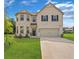 Charming two-story brick home with a two-car garage and well-manicured lawn at 49 Ryder Pass Way, Loganville, GA 30052