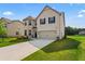 Stunning two-story brick home with a well-manicured lawn and a spacious driveway at 49 Ryder Pass Way, Loganville, GA 30052