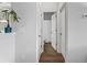 Bright hallway with a view of the bathroom featuring hardwood floors and a neutral color palette at 49 Ryder Pass Way, Loganville, GA 30052