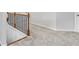 Upstairs hallway featuring neutral carpet and a black wrought iron bannister at 49 Ryder Pass Way, Loganville, GA 30052