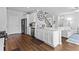 Bright kitchen with a center island, stainless steel appliances, and open-concept living space at 49 Ryder Pass Way, Loganville, GA 30052