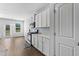 Modern kitchen featuring white cabinets, stainless steel appliances, and a backsplash at 49 Ryder Pass Way, Loganville, GA 30052