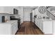 Modern kitchen showcasing white cabinetry, quartz countertops, and stainless steel appliances at 49 Ryder Pass Way, Loganville, GA 30052